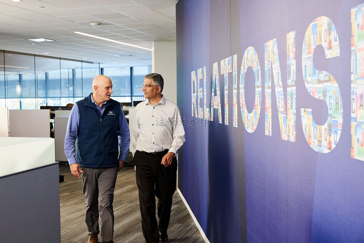 Two Wheels employees walking down hallway of Wheels office